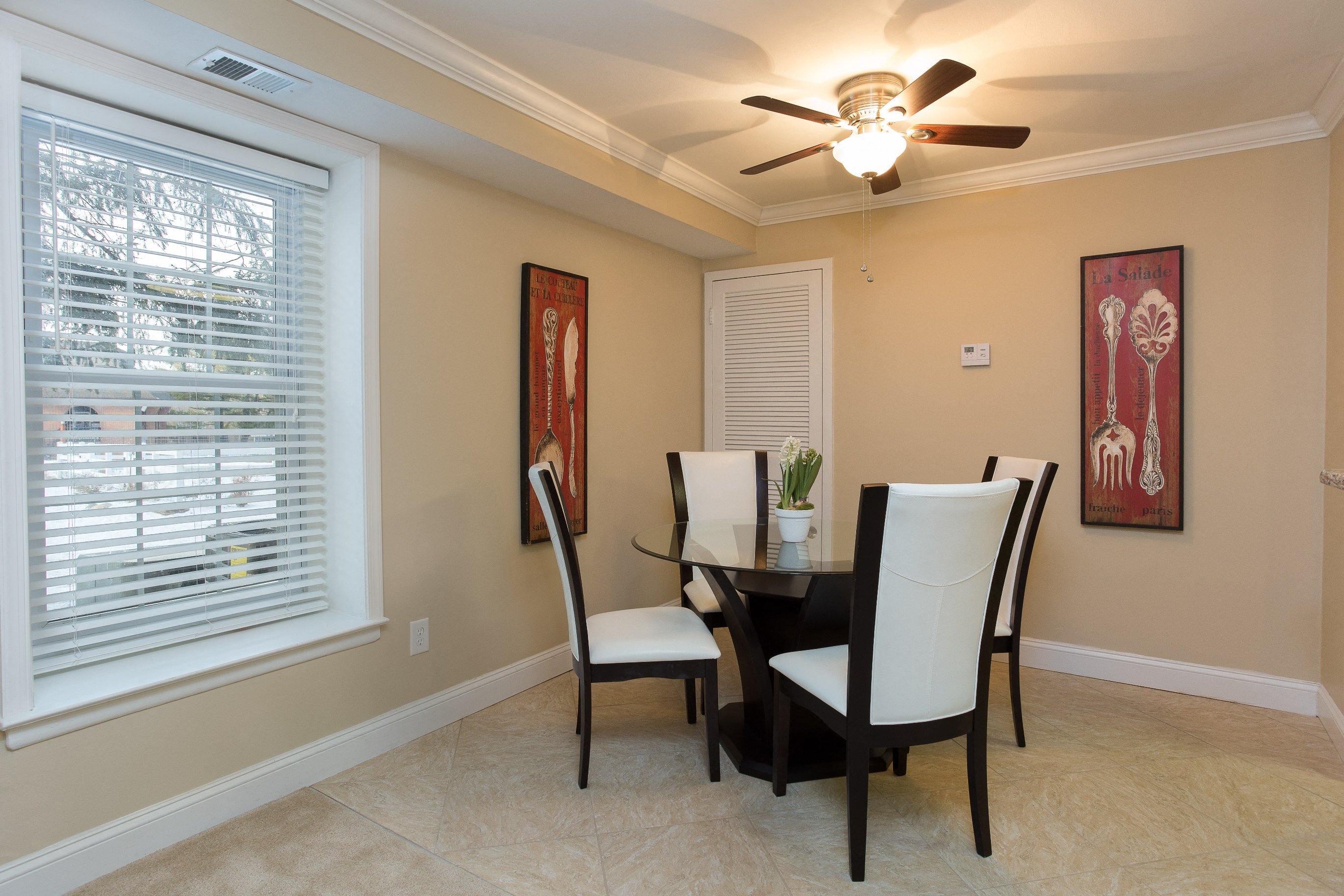 Furnished dining room with window and ceiling fan